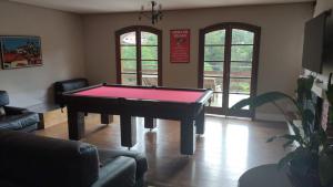 a living room with a pool table in a room at Pousada Château dos Fontes in Campos do Jordão