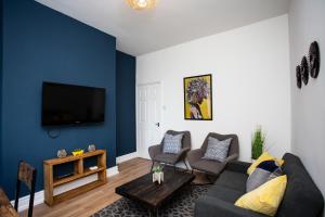 a living room with a couch and chairs and a tv at Chirton House by #ShortStaysAway in North Shields