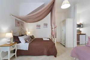 a bedroom with a large bed with a canopy at DIMORA FEO in Gallipoli