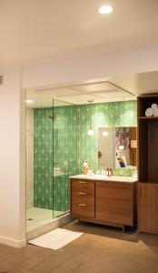a bathroom with a glass shower and a sink at RISE Uptown in Phoenix