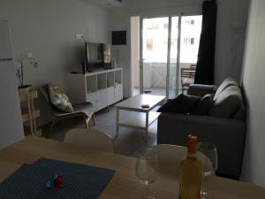 a living room with a couch and a table at Corralejo Sun 103 wifi free in Corralejo