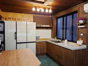 a kitchen with a sink and a refrigerator at Batwo Stay - For foreigners only in Seoul