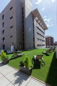 
a large building with a lawn chair in front of it at Sercotel Gran Fama in Almería
