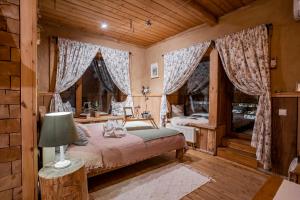 a bedroom with a bed and two windows at Guest House Old Boys in Krasnaya Polyana