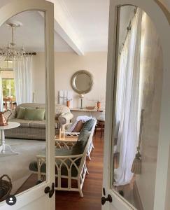 a living room with a couch and a mirror at Little Woodbank in Portadown