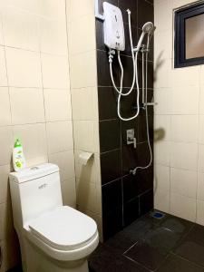 a bathroom with a toilet and a shower at Bunga Homestay Hill View in Kuala Terengganu