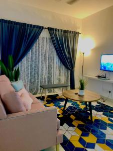 a living room with a couch and a table at Bunga Homestay Icon Residence KUALA TERENGGANU in Kuala Terengganu
