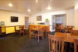 a dining room with wooden tables and chairs at Weatherford Heritage Inn in Weatherford