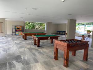 a room with ping pong tables in the middle at Rio Quente Flat Veredas Apto - 231 in Rio Quente