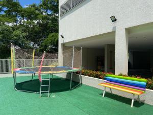 a playground with a trampoline and a colorful bench at Rio Quente Flat Veredas Apto - 231 in Rio Quente