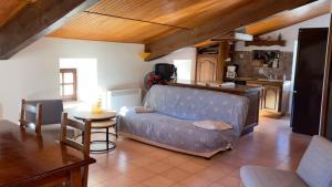 a living room with a couch and a table at Le Gîte De Babeth in Saint-Maurice-dʼIbie