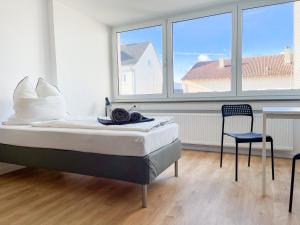 Postel nebo postele na pokoji v ubytování Hegau Boardinghouse