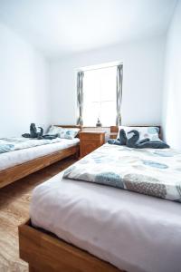 1 dormitorio con 2 camas y ventana en Pension-Cafe-Konditorei Mikl, en Hallein