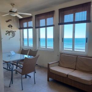 a living room with a couch and a table and chairs at Agua Marina in Arenales del Sol