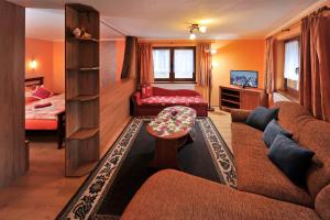 a living room with a couch and a bed at Penzión Lampáš in Poprad