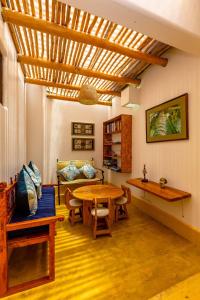 a living room with a table and a couch at Casa del Rocío - Desing Beach House in Máncora
