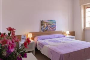 Postel nebo postele na pokoji v ubytování VILLA ISCHIA