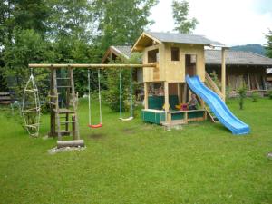 a play house with a slide and a playground at Gästehaus Kress - Chiemgau Karte in Inzell