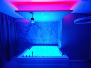 a bathroom with a tub with neon lights at Diamond Suite Verona in Verona