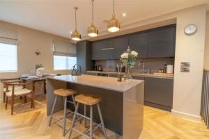 eine Küche mit einer großen Insel mit Barhockern in der Unterkunft Entire 2 Bed - Free Parking - No. 15 - The Cosy Collection Ltd in York + 14 Fotos