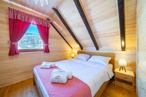 a bedroom with two beds in a wooden house at Zara Chalet in Kolašin +43 photos