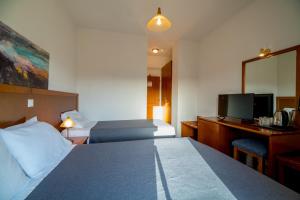 Postel nebo postele na pokoji v ubytování Hiona Holiday Hotel