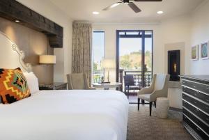 a bedroom with a large bed and a living room at The Wilde Resort and Spa in Sedona