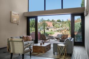 a living room filled with furniture and a window at The Wilde Resort and Spa in Sedona