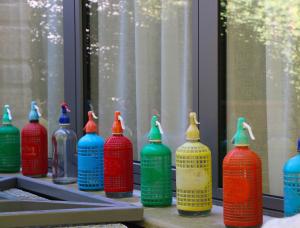 a group of colorful vases sitting on a window sill at Les Nuits Pétillantes in Cournonterral