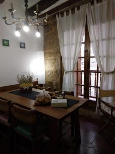 a dining room with a table and a window at Lo Cremallé in Valderrobres