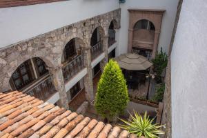 an overhead view of a building with a patio and a tree at El Alcazar in San Miguel de Allende