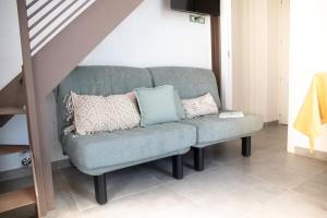 a couch with pillows on it in a living room at New Agriloft 3 Agave - Giardino, WI-Fi, clima, a 50 mt dal mare in Bordighera