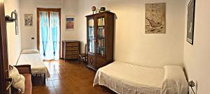 a bedroom with two beds and a dresser in it at Sea home in Alghero