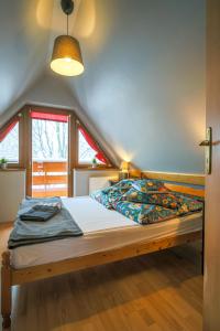 a bedroom with a bed with a wooden frame at Golden Apartments Zakopane&B13 in Zakopane