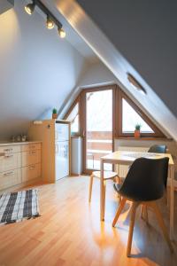 a kitchen with a table and a chair in a room at Golden Apartments Zakopane&B13 in Zakopane