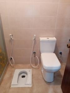 a bathroom with a toilet with a drain in the floor at the prince apartment شقة الامير in Wadi Musa