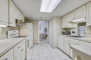 a kitchen with white cabinets and white appliances at Sea Watch Condos IV in Ocean City