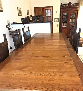 a large wooden table in a room with chairs at Sea home in Alghero