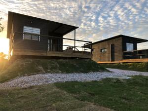 a house on top of a hill with the sun setting at La Sifrina Punta Negra in Punta Colorada