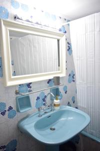 a bathroom with a sink and a mirror at Antonia's 2bedroom with garden and private parking by MK in Piraeus