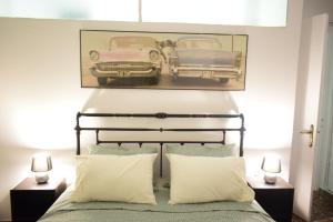 a bedroom with a bed with two cars on the wall at Antonia's 2bedroom with garden and private parking by MK in Piraeus