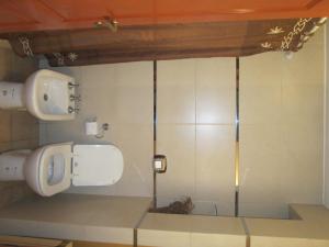 a bathroom with two toilets in a room at Aires del Parque in Salta