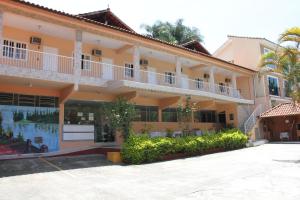 a large yellow building with a lot of windows at Pousada Al Chaddai in São Lourenço +68 photos