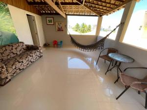 a living room with a couch and a hammock at Casa cinza in Aracaju