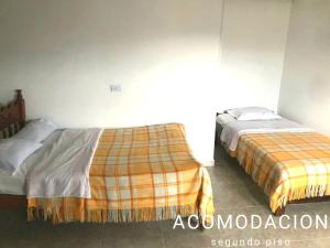 a bedroom with two beds in a room at Hostal Diana in San Agust&iacute;n