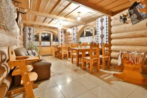 a dining room with wooden tables and chairs at Willa Jarząbek - 5 min do Term in Szaflary