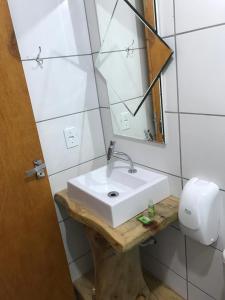 a bathroom with a white sink and a mirror at Cabana da Colina 2 in Bom Jardim da Serra