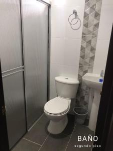 a bathroom with a toilet and a sink at Hostal Diana in San Agustín