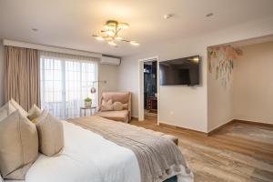 TV a/nebo společenská místnost v ubytování Hotel Casa Arum