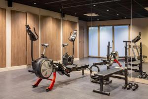 a gym with several exercise equipment in a room at Best Western Plus Le Conquerant Rouen Nord in Bois-Guillaume